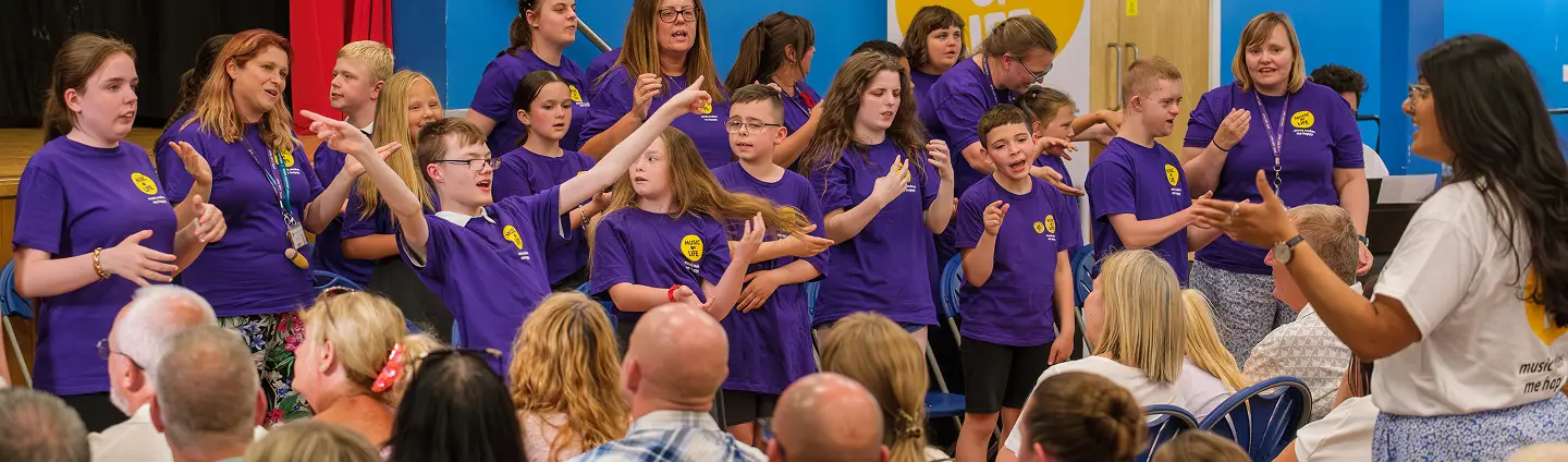 Children and adults performing music together during a Music of Life session.